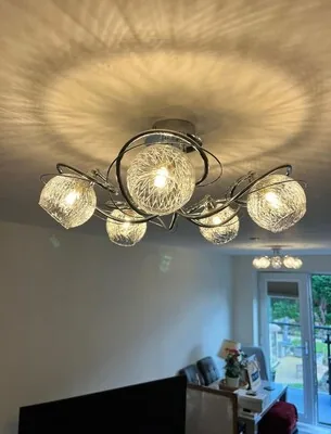 Chrome and glass multi-arm ceiling light in a living room