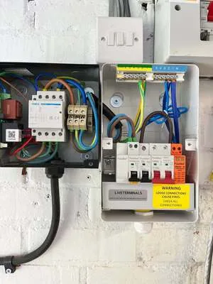 Small consumer unit beside a contactor enclosure with neatly terminated wiring