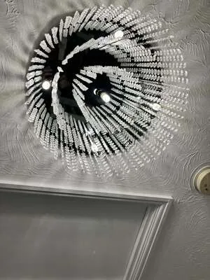 Decorative crystal ceiling light casting patterns on a textured ceiling