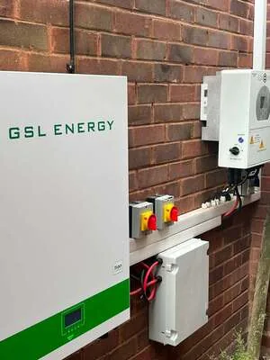 GSL Energy battery storage with isolators on an exterior brick wall